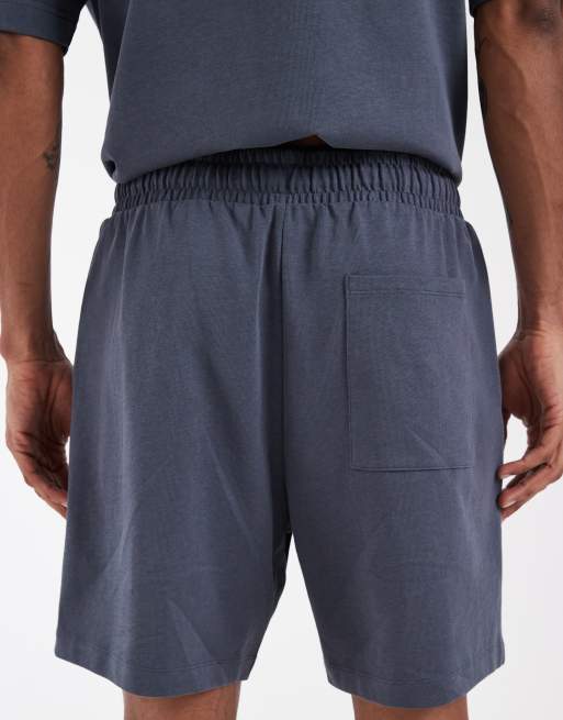 ASOS DESIGN Circular Design Collection pleated oversized jersey shorts in navy, 5 of 5