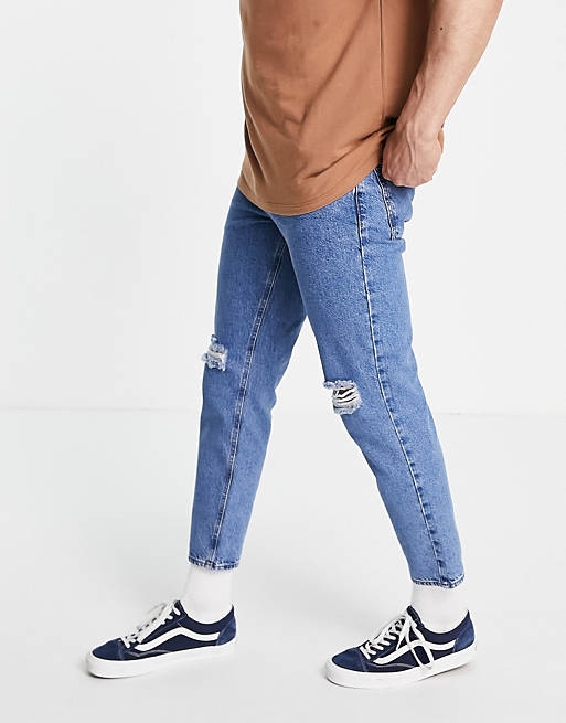 ASOS DESIGN classic rigid jeans in flat mid blue with knee rips