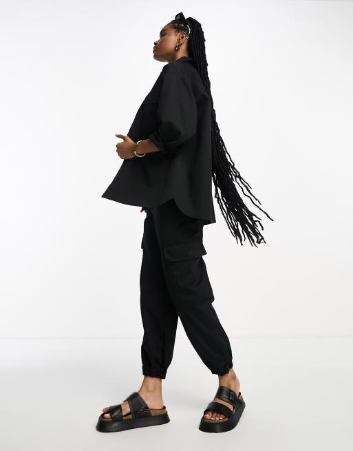 ASOS DESIGN clean cargo trackies with tie waist in black (part of a set)