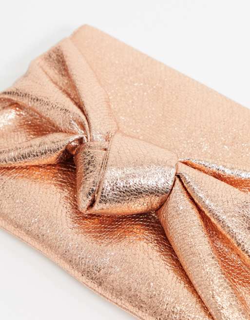 ASOS DESIGN clutch bag with oversized bow in rose gold