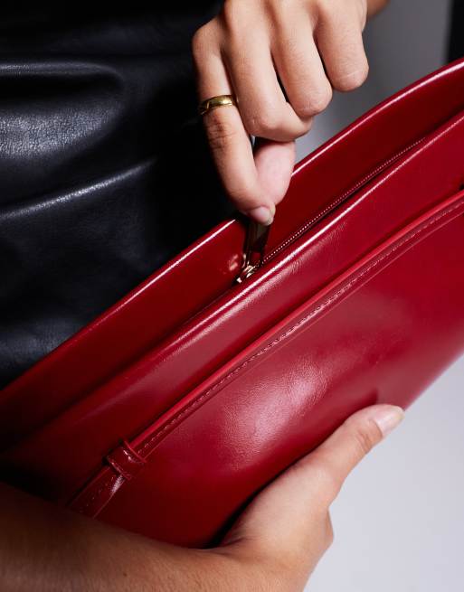 ASOS DESIGN clutch bag with skinny buckle strap detail in red