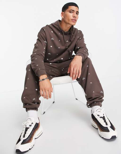 ASOS DESIGN co-ord oversized joggers in brown with all over symbol prints - MULTI