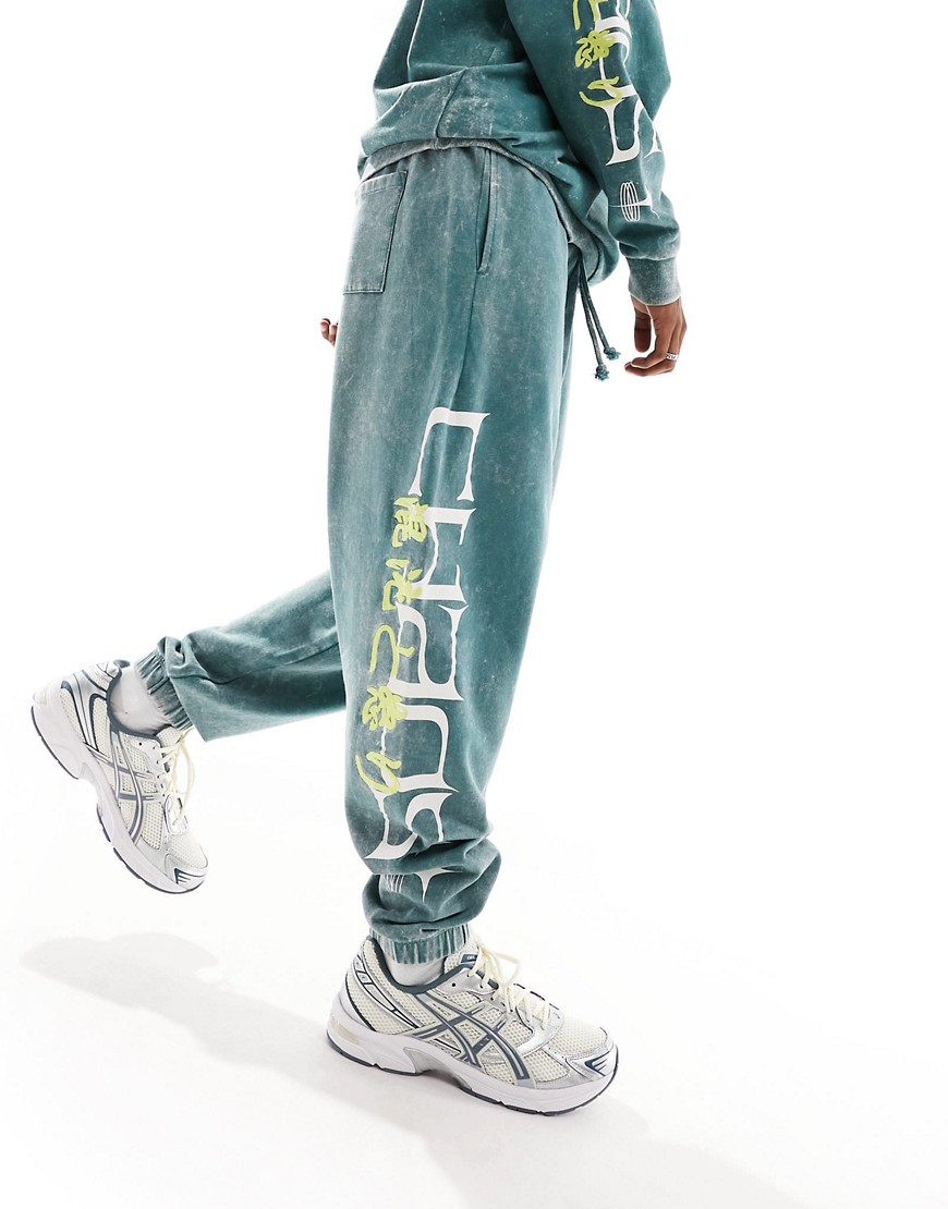 ASOS DESIGN co-ord oversized joggers in dark green acid wash with side text print & embroidery
