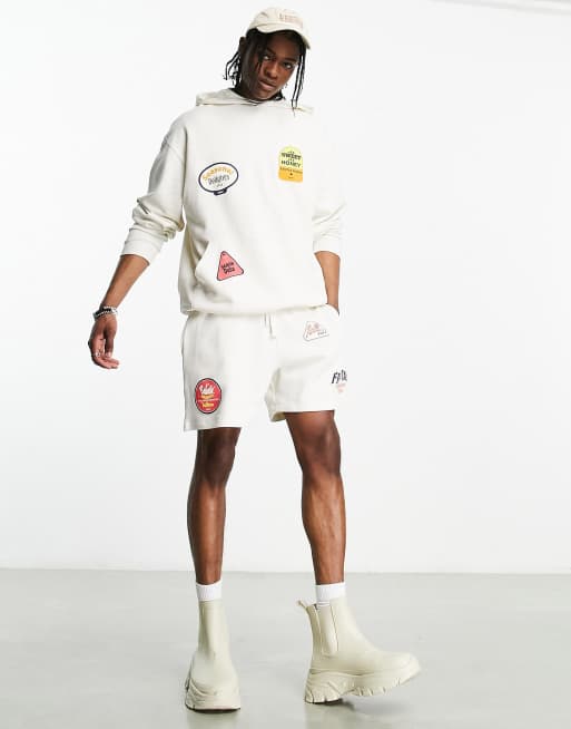 ASOS DESIGN co-ord oversized shorts in off white with multiplacement fruit sticker print