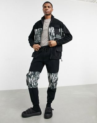 ASOS DESIGN co-ord polar fleece tapered joggers with abstract camo panels & utility pockets in black