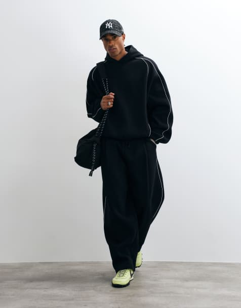 ASOS DESIGN - Co-ord set van extreem oversized hoodie en joggingbroek met ballonpijpen en biezen van poly-katoen in zwart - view 1