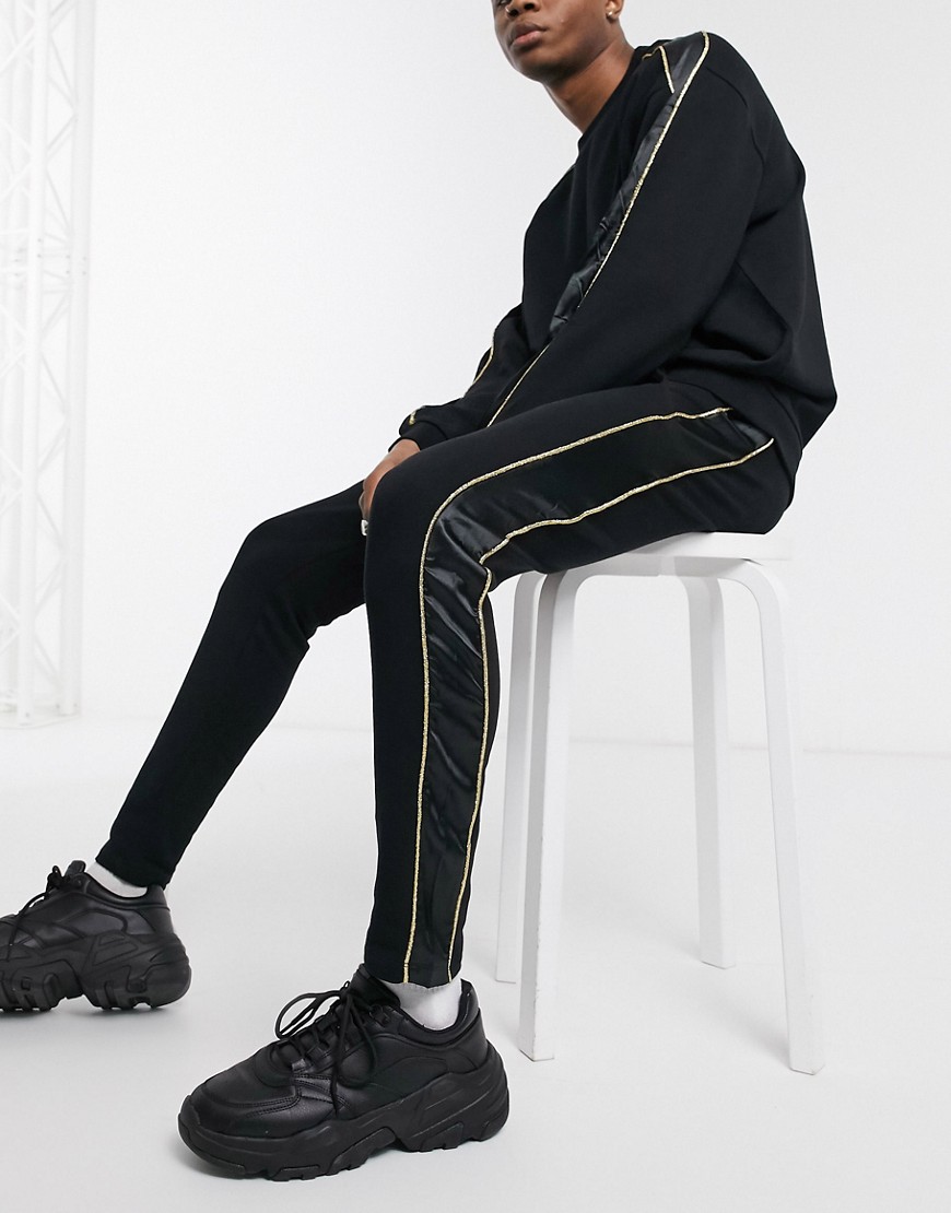 ASOS DESIGN co-ord skinny joggers with satin & gold piping side stripe in black