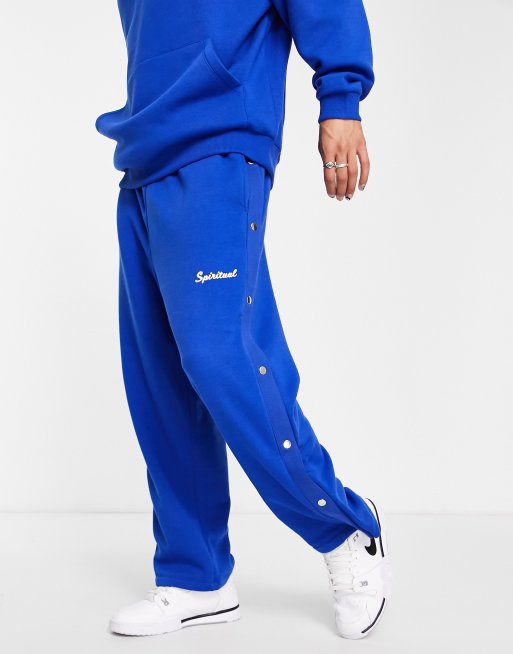 ASOS DESIGN co-ord straight leg joggers in blue with side poppers and text  print