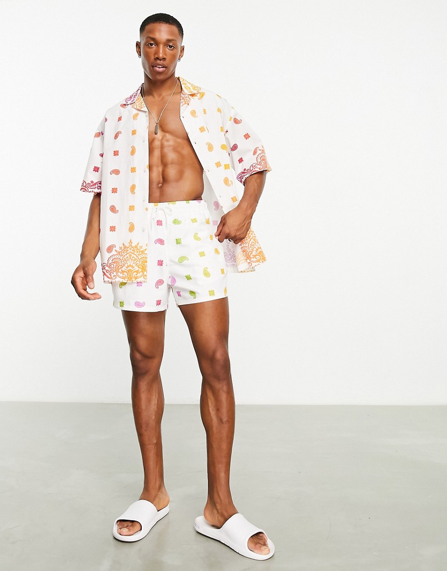 ASOS DESIGN co-ord swim shorts in short length in rainbow bandana print-Multi