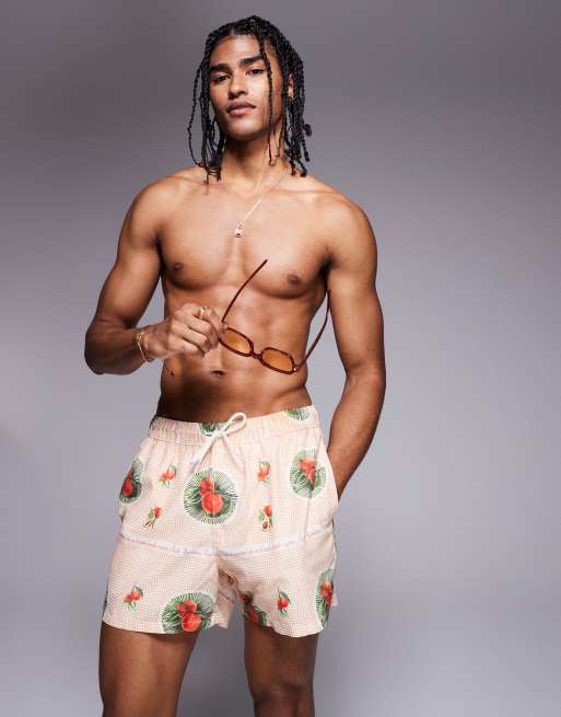 ASOS DESIGN co-ord swim shorts in short length with fruit design in orange