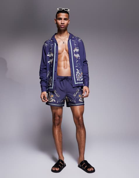 ASOS DESIGN co-ord swim shorts in short length with pattern border in navy - view 1