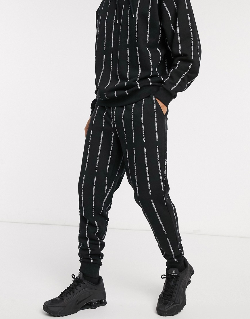 ASOS DESIGN co-ord tapered jogger in black with white text stripe print