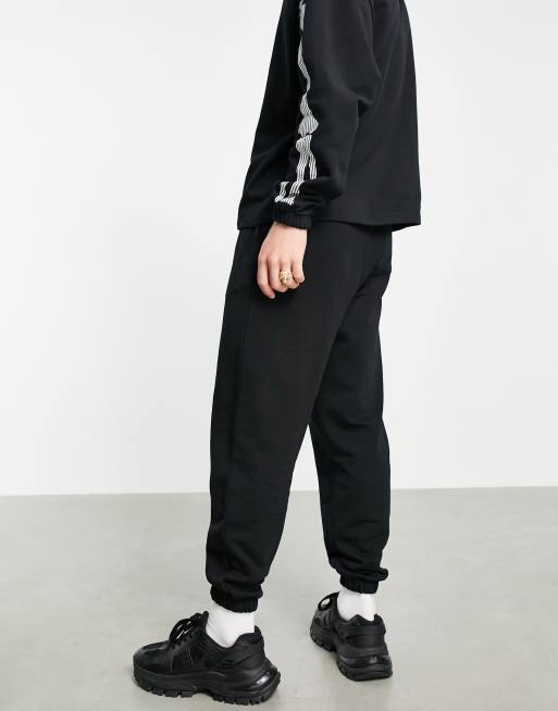 ASOS DESIGN co-ord tapered trackies with Halloween skeleton print in black, 2 of 4