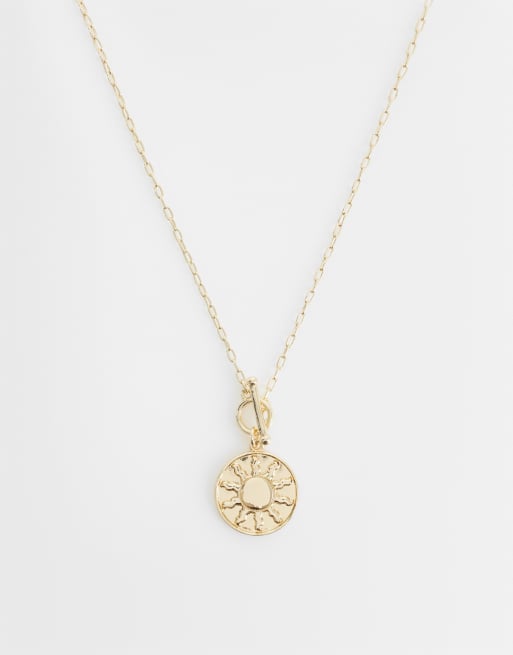 ASOS DESIGN - Collana color oro con ciondolo a forma di sole e barretta a T