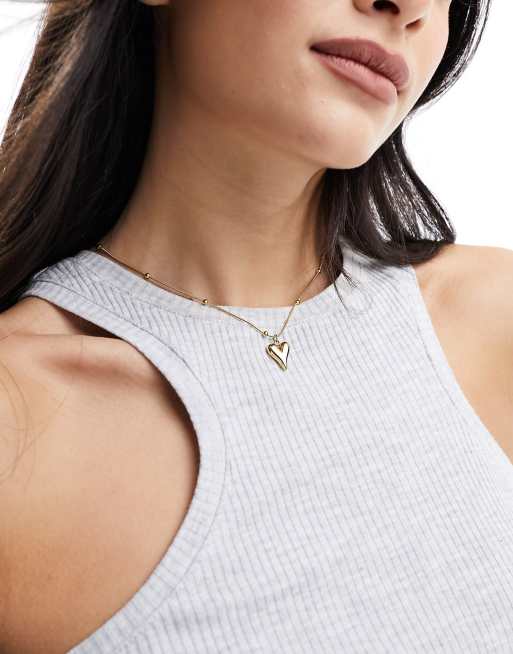 ASOS DESIGN - Collana in acciaio inossidabile resistente all'acqua color oro con ciondolo a cuore bombato