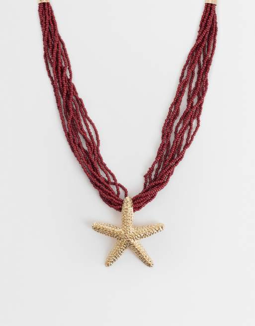 ASOS DESIGN - Collana multifilo con perline bordeaux e ciondolo a stella marina color oro