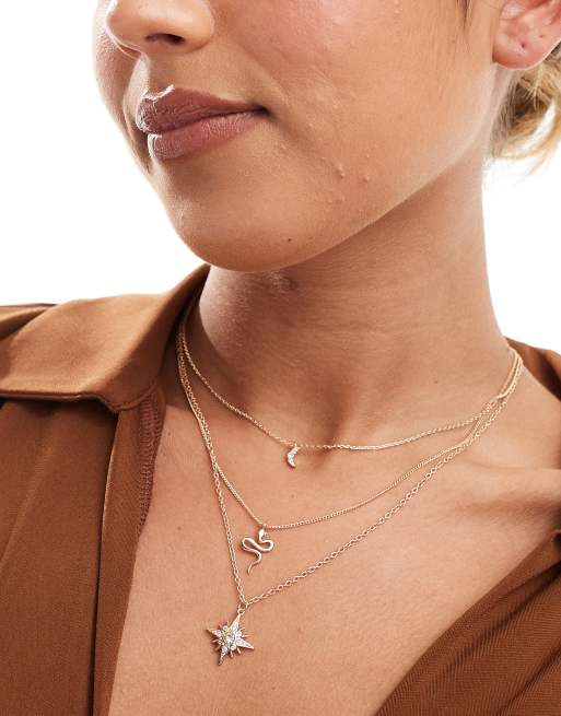 ASOS DESIGN - Collana multifilo dorata con ciondoli a forma di serpente e corpi celesti
