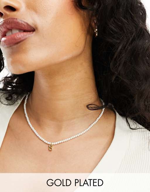ASOS DESIGN - Collana placcata oro 14 k con segno zodiacale del Toro e con perle in vetro sintetico in confezione regalo