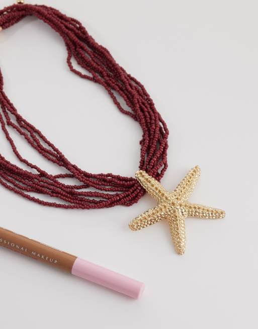 ASOS DESIGN - Collar dorado de varias hileras con cuentas burdeos y colgante de estrella de mar, 2 de 4