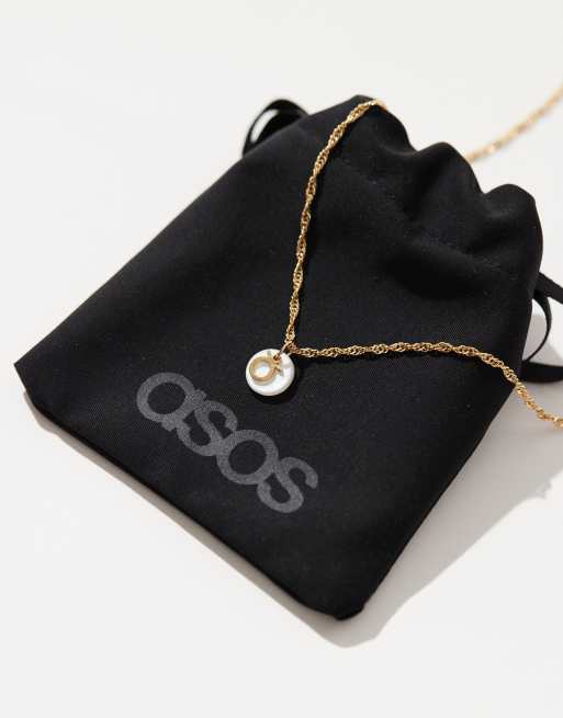 ASOS DESIGN - Collier en plaqué or 14 carats à pendentif disque en perle fantaisie et symbole du signe astrologique Taureau avec pochette cadeau