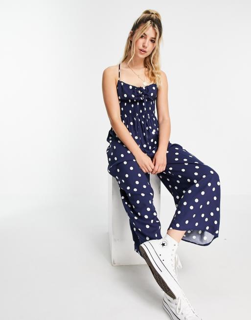ASOS DESIGN - Combinaison jupe-culotte nouée devant avec taille froncée - Bleu marine à pois crème