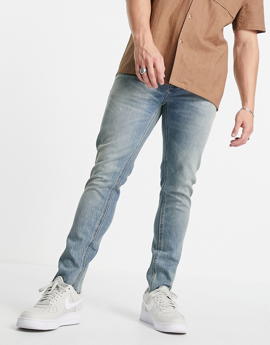 ASOS DESIGN - Cone Mill - Denim 'American classic' skinny jeans in vintage mid wash met onafgewerkte zoom-Blauw