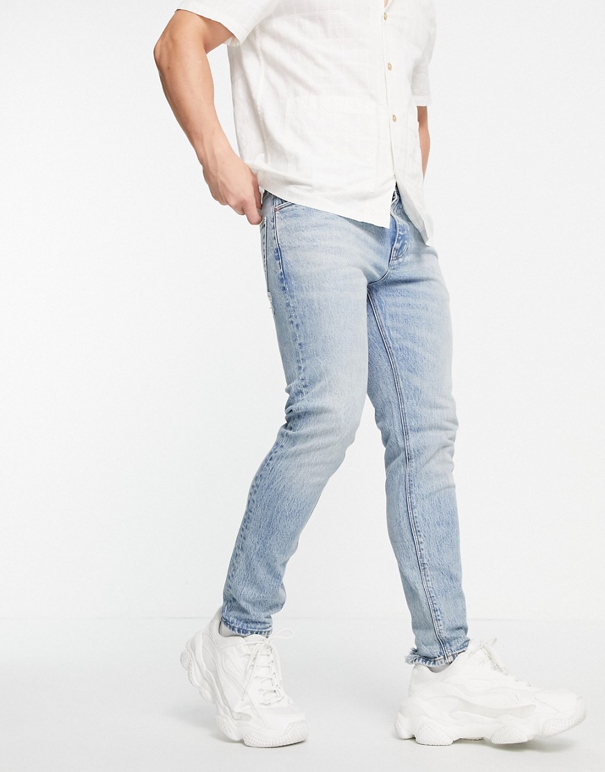 ASOS DESIGN - Cone Mill Denim - Skinny fit 'American classic' jeans in vintage medium wassing-Blauw