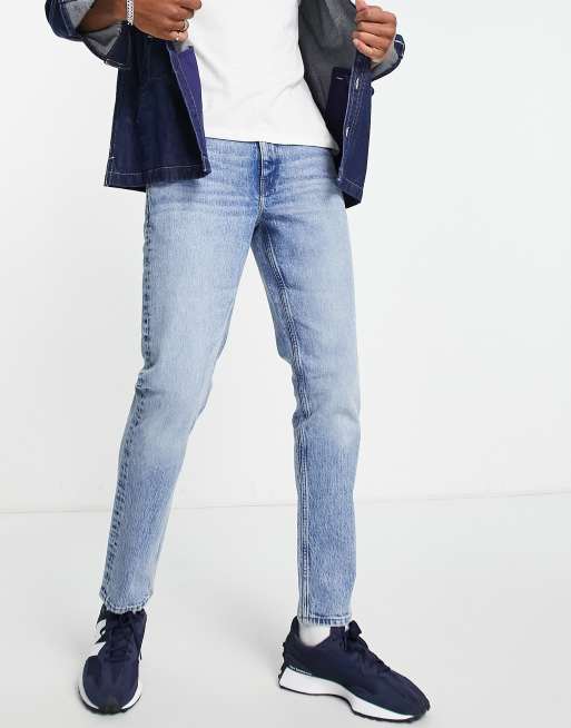 ASOS DESIGN stretch tapered jeans in 90s mid wash