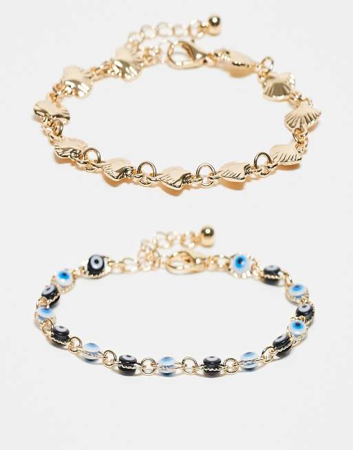 ASOS DESIGN - Confezione da 2 bracciali color oro con conchiglie sintetiche e occhi
