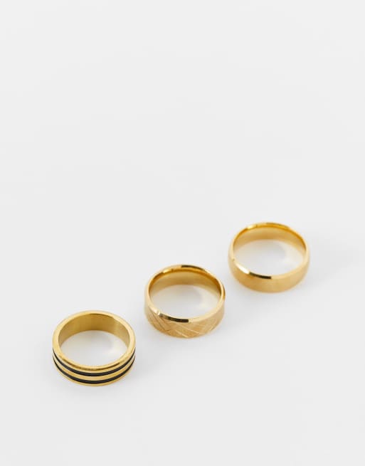 ASOS DESIGN - Confezione da 3 anelli a fascia in acciaio inossidabile resistente all'acqua color oro con dettagli neri 