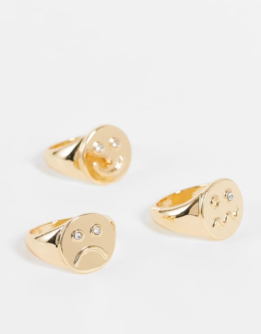 ASOS DESIGN - Confezione da 3 anelli assortiti con faccine con emozioni oro