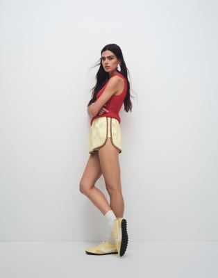 ASOS DESIGN contrast seam satin runner shorts in yellow and mocha