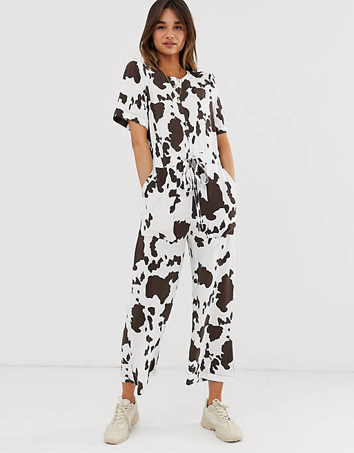 ASOS DESIGN contrast stitch t-shirt jumpsuit in cow animal print