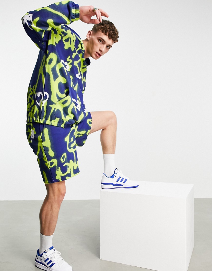 ASOS DESIGN coordinating oversized jersey shorts with all over graffiti print-Multi