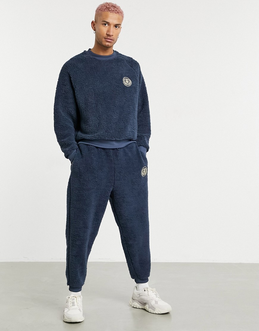 ASOS DESIGN coordinating oversized teddy borg sweatpants with crest embroidery in navy