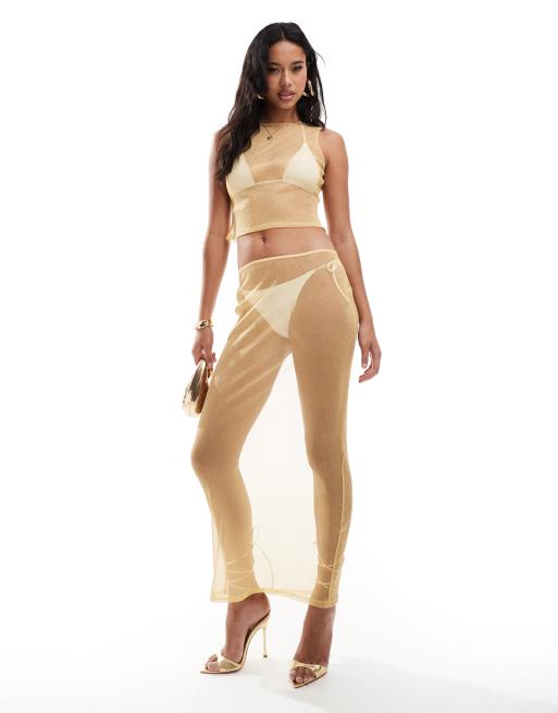 ASOS DESIGN - Coordinato trasparente lucido con top senza maniche e gonna color oro
