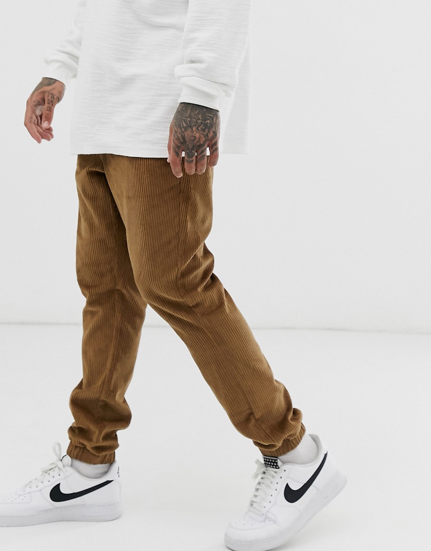 ASOS DESIGN cord tapered cuffed joggers in tan-Beige