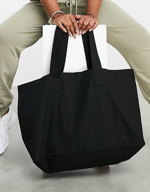 passion Introduce Conjugate ASOS DESIGN cotton canvas tote bag in black - BLACK | ASOS