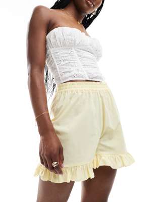 ASOS DESIGN ASOS DESIGN cotton frill hem shorts in buttermilk-Yellow