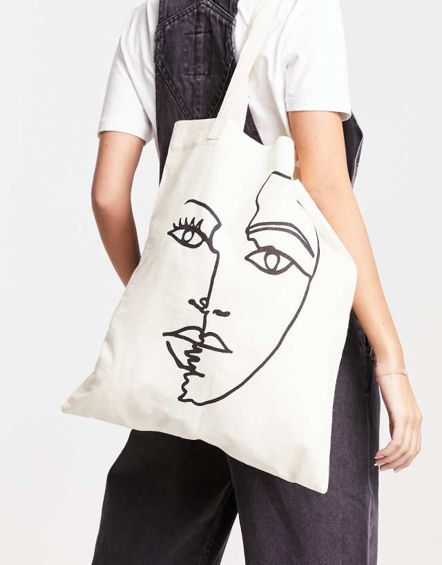 ASOS DESIGN cotton tote bag with placement abstract face print