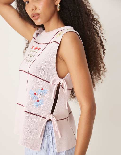ASOS DESIGN crew neck knit tabard tank top with floral embroidery in pink