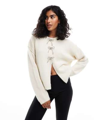 crew neck oversized cardigan with diamante bow buttons in cream-White