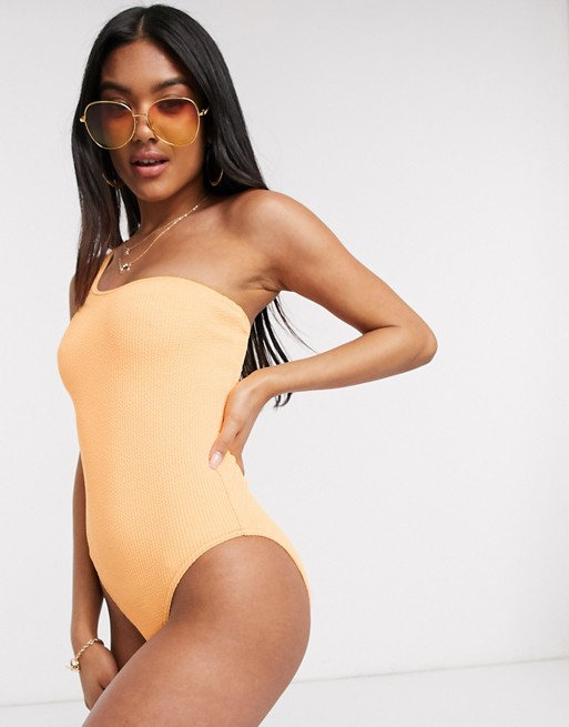 ASOS DESIGN crinkle one shoulder swimsuit in faded fluro orange
