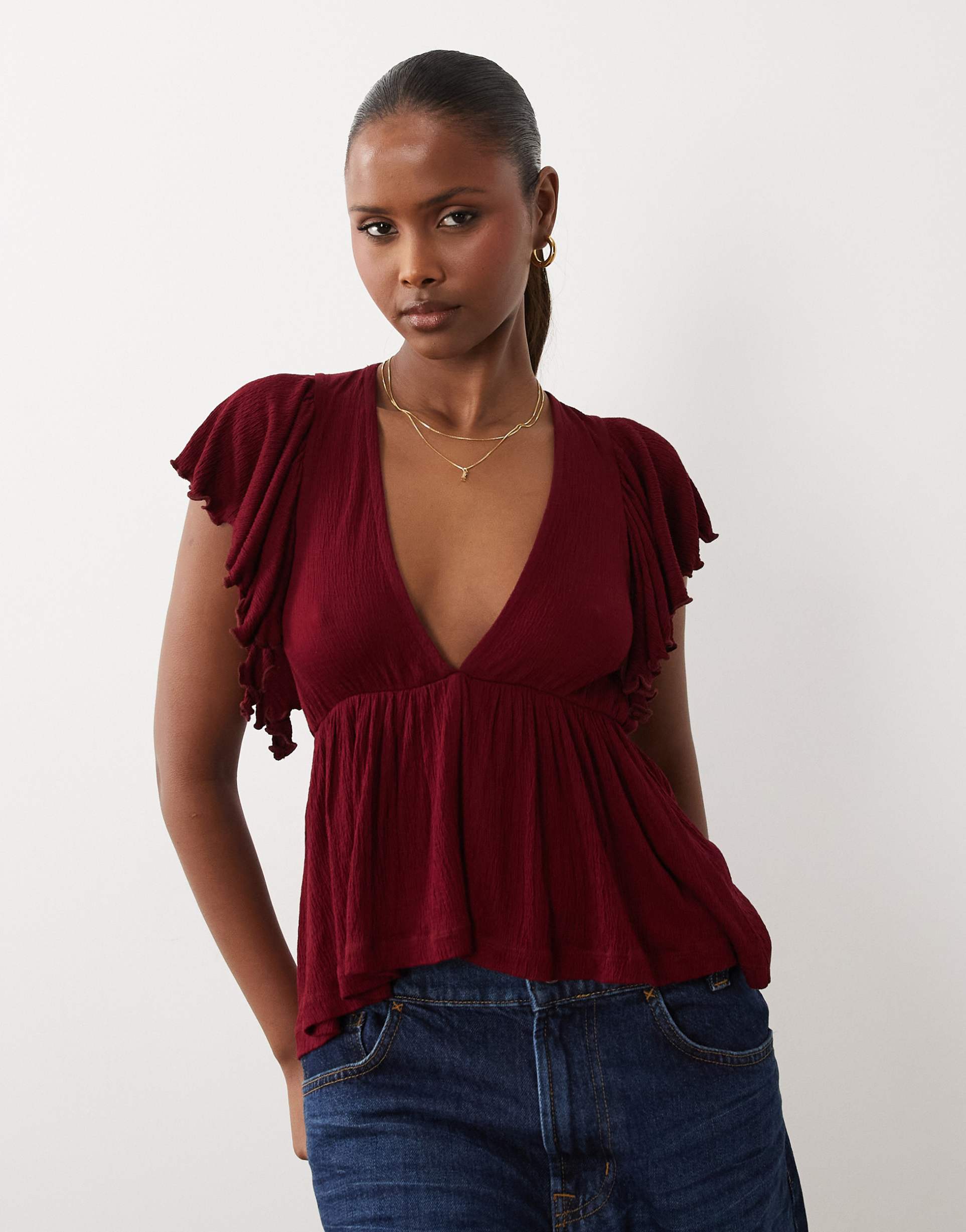 asos design crinkle plunge neck ruffle flutter sleeve top in berry