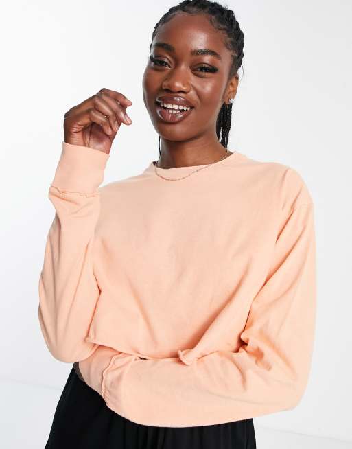 ASOS DESIGN - Crop top coupe carrée avec ouvertures pour les pouces - Corail délavé