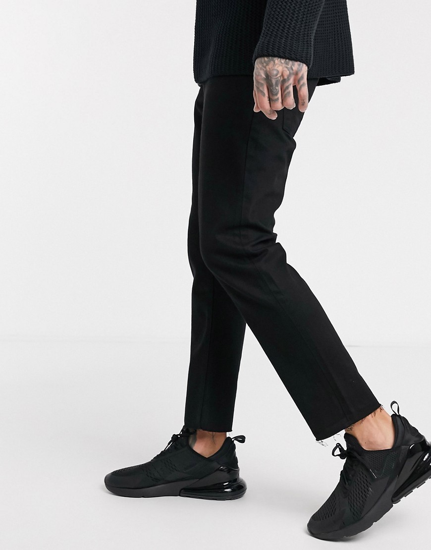 ASOS DESIGN cropped rigid slim jeans in black with raw hem