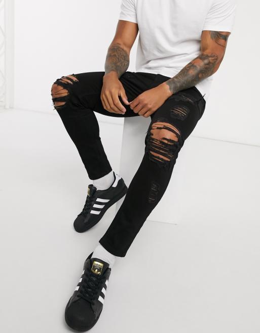 ASOS DESIGN cropped skinny jeans in black with heavy rips