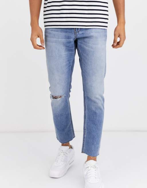 ASOS DESIGN cropped slim jeans in light wash with raw hem and knee rip ...