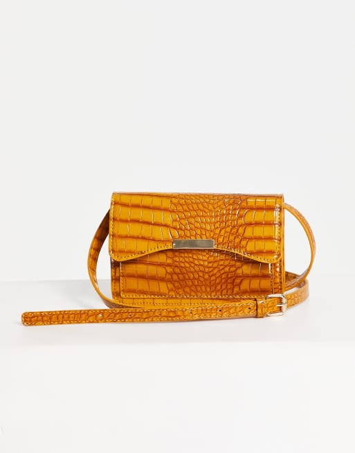 ASOS DESIGN cross body bag with bar lock detail in mustard croc