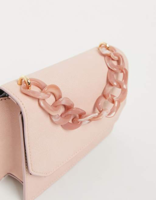 ASOS DESIGN resin clutch bag with detachable multi colored chain in pink